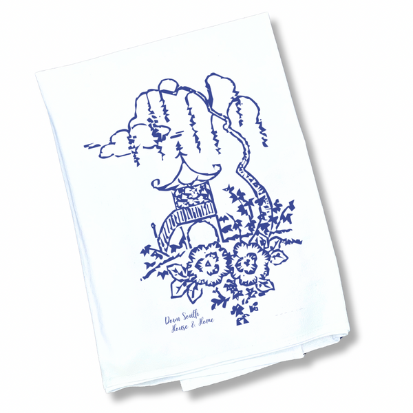 White towel with blue willow floral design and text on a white background