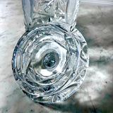 Inside of the lid of a Vintage Zawiercie Laurencie Cut Glass Tall Crystal Cracker Jar with jar standing behind it on a mottled gray surface.