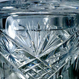 Close-up of Vintage Zawiercie Laurencie Cut Glass Tall Crystal Cracker Jar with intricate geometric facets and starburst patterns reflecting light.