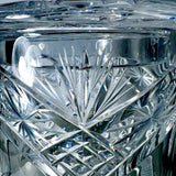 Close-up of Vintage Zawiercie Laurencie Cut Glass Tall Crystal Cracker Jar with intricate geometric facets and starburst patterns reflecting light.